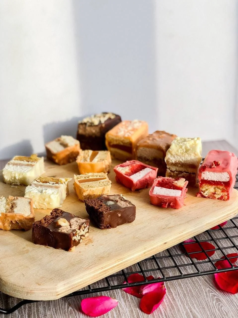 An assortment of small layered cakes cut to reveal their interiors